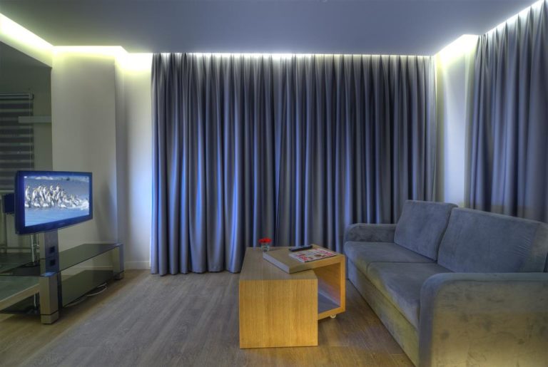Светодиодная лента в интерьере гостиной на стене